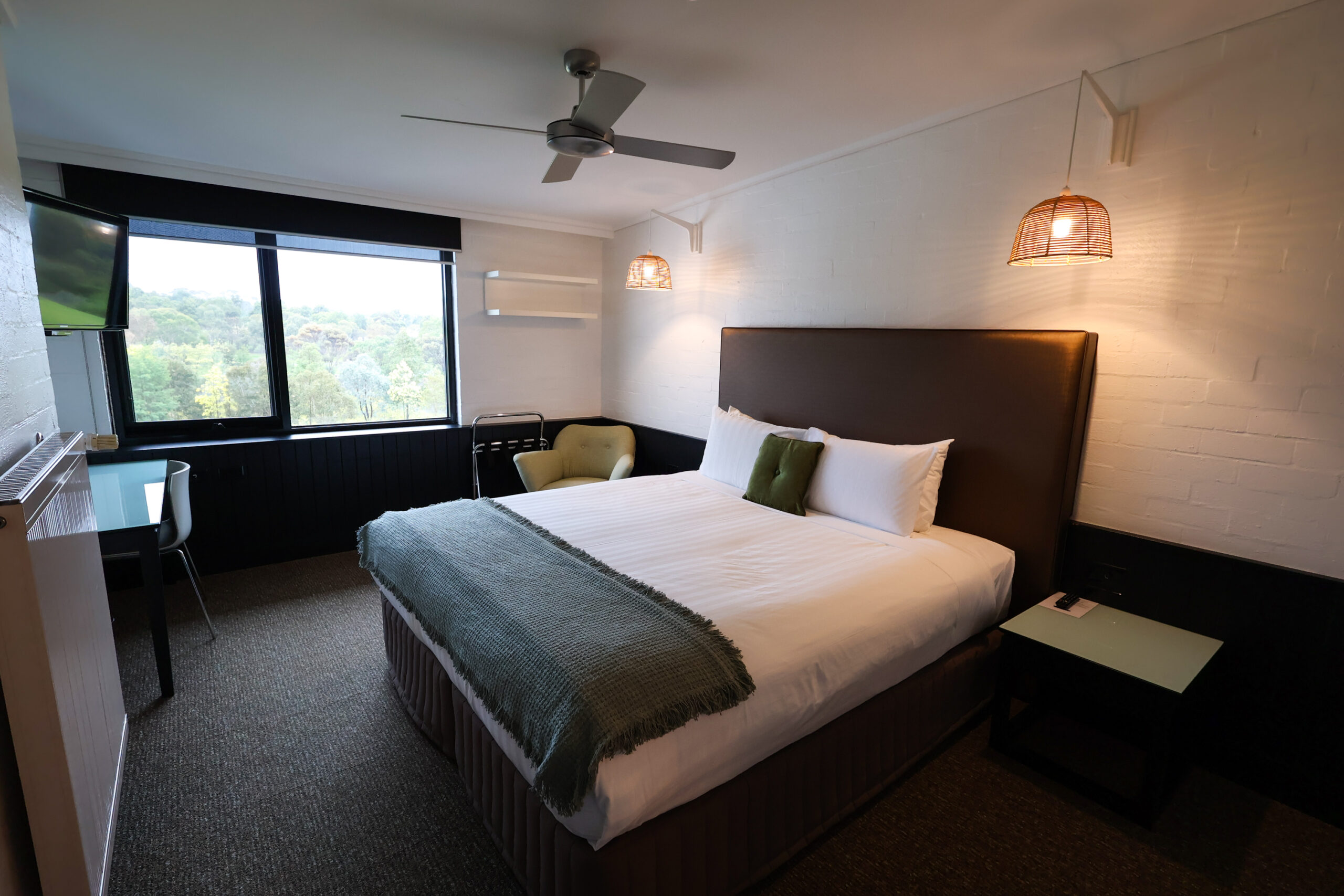 Bedroom of Standard Room at Waurn Ponds Estate. Bed made and neatly presentated with view of nature outside the window.